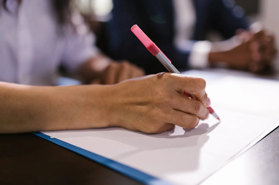 Close-up of a pen signing a formal legal document.